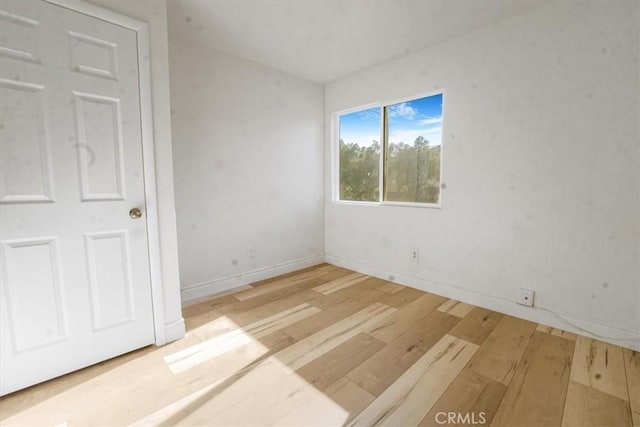 spare room featuring light hardwood / wood-style floors