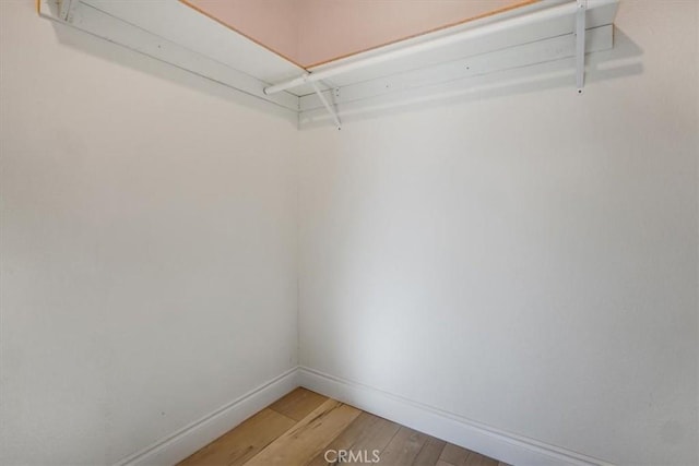 spacious closet featuring hardwood / wood-style floors