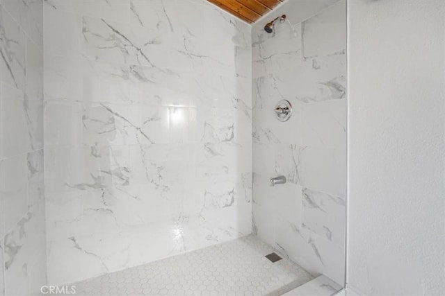 bathroom with a tile shower