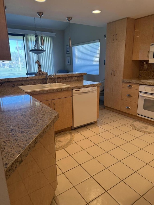 kitchen featuring backsplash, sink, white appliances, light tile patterned flooring, and hanging light fixtures