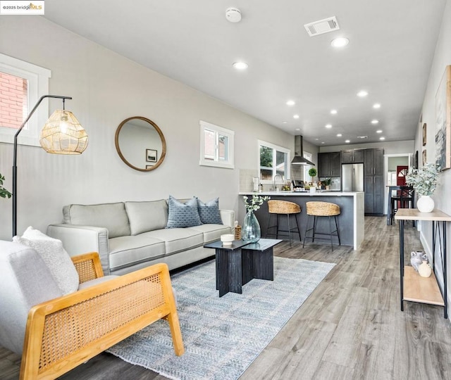 living room featuring hardwood / wood-style flooring and sink