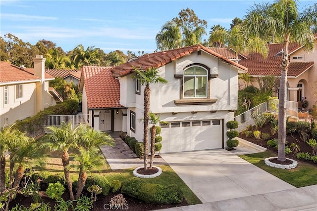 mediterranean / spanish-style house with a garage