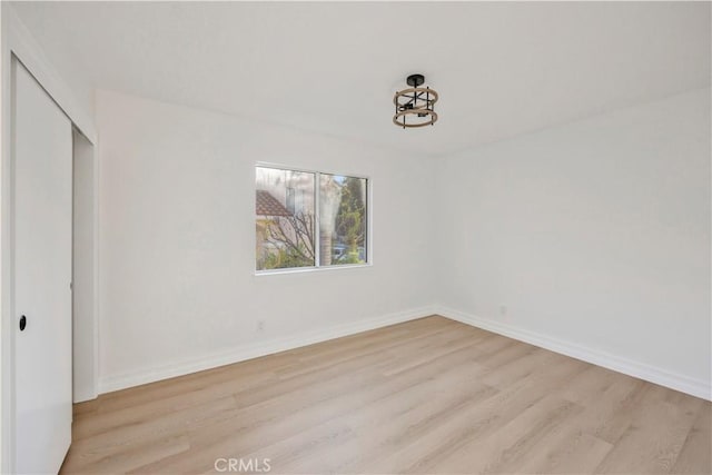 unfurnished bedroom with light wood-type flooring and a closet