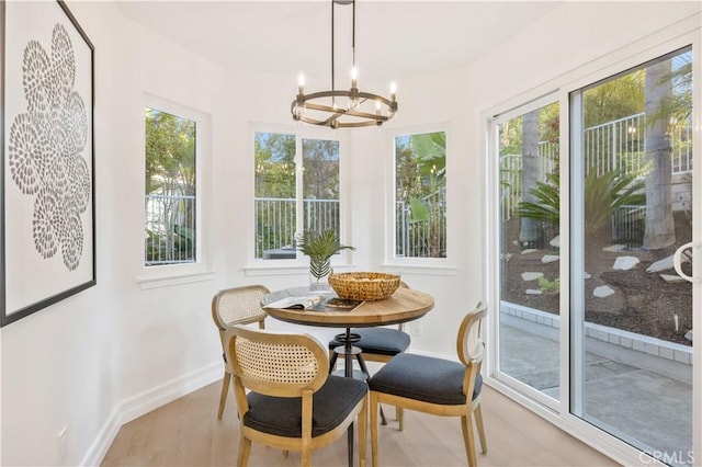 sunroom / solarium with a wealth of natural light and a notable chandelier