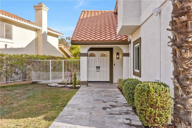 property entrance with a lawn