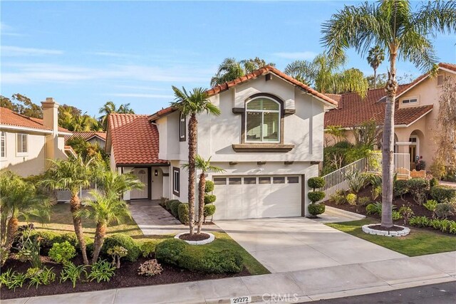 mediterranean / spanish-style home featuring a garage