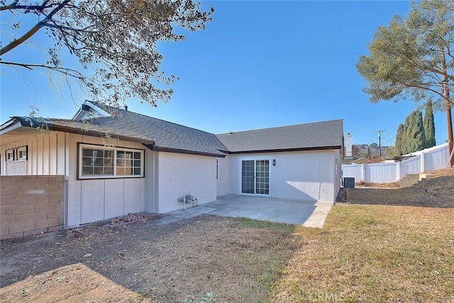 rear view of house featuring a patio area and a yard