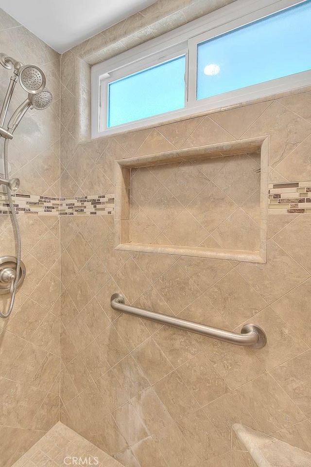 bathroom with tiled shower