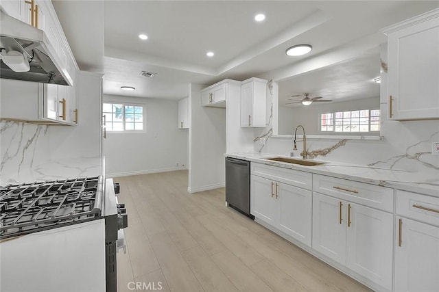 kitchen with appliances with stainless steel finishes, white cabinets, backsplash, and sink