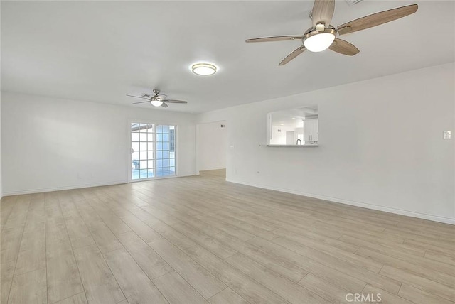 unfurnished room with ceiling fan and light hardwood / wood-style flooring