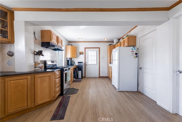 kitchen featuring decorative backsplash, light wood-type flooring, white refrigerator, and stainless steel range with gas stovetop