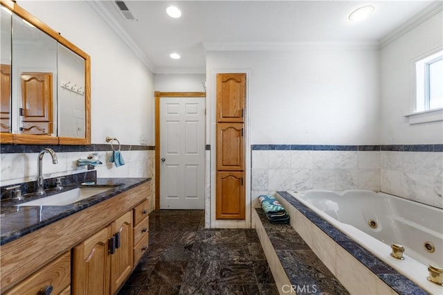 bathroom featuring ornamental molding, tiled tub, and vanity