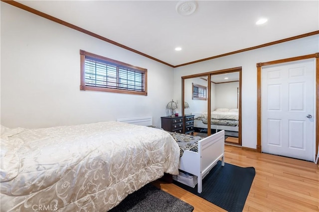 bedroom featuring ornamental molding and hardwood / wood-style floors