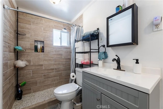 bathroom with toilet, ornamental molding, vanity, and curtained shower