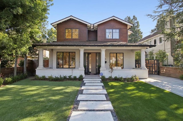 view of front of house featuring a front yard and a porch