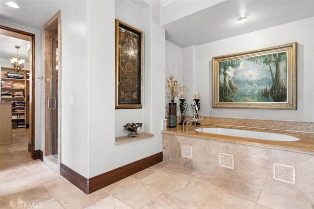 bathroom featuring plus walk in shower and a chandelier