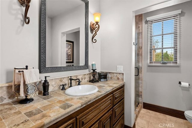 bathroom with toilet, a shower with shower door, and vanity