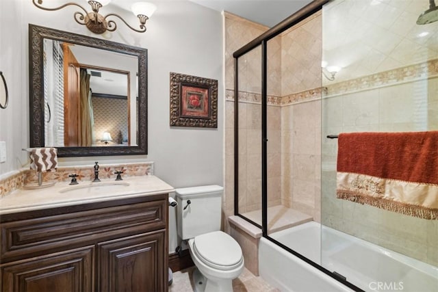 full bathroom with combined bath / shower with glass door, vanity, and toilet