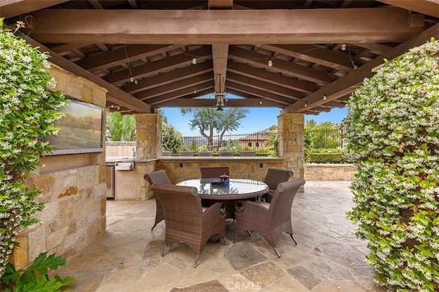 view of patio with an outdoor kitchen and a gazebo