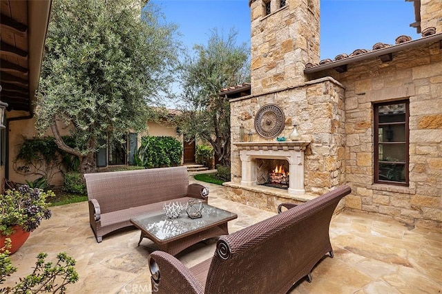 view of patio / terrace with an outdoor living space with a fireplace