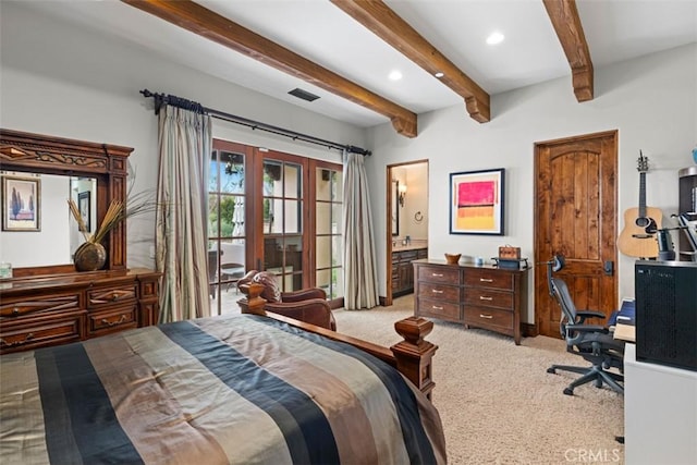 bedroom with carpet floors, ensuite bathroom, beam ceiling, and french doors