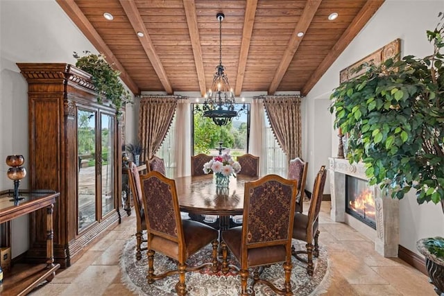 dining area with wooden ceiling, a high end fireplace, lofted ceiling with beams, and a chandelier