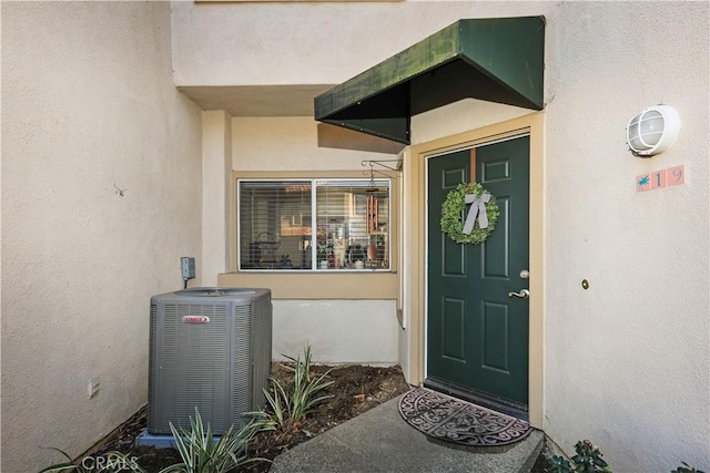 doorway to property featuring central air condition unit