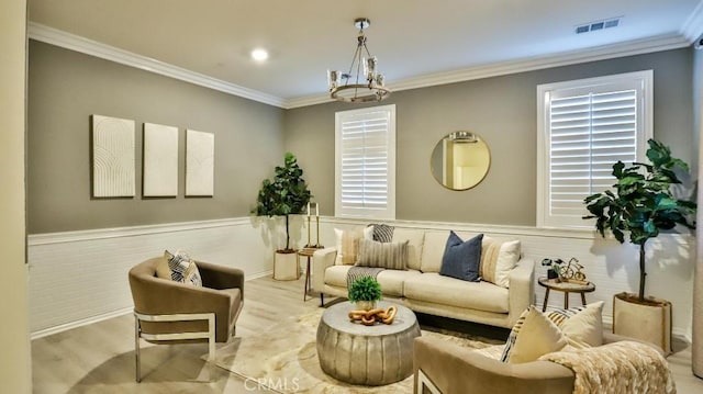 living area with light hardwood / wood-style floors and crown molding