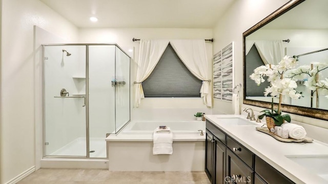 bathroom featuring vanity and independent shower and bath