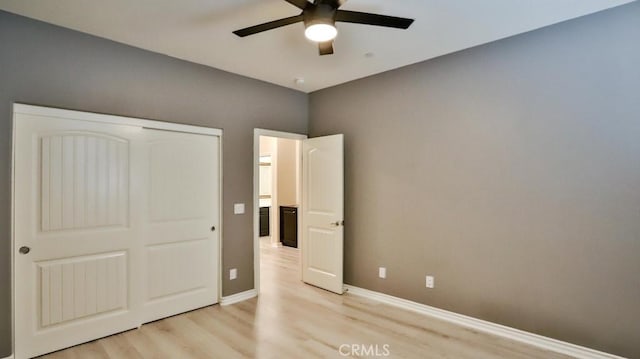 unfurnished bedroom featuring ceiling fan, a closet, and light hardwood / wood-style flooring