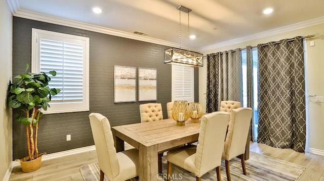 dining room featuring ornamental molding and light hardwood / wood-style flooring