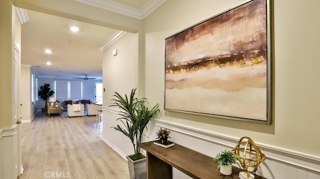 corridor featuring ornamental molding and light hardwood / wood-style flooring