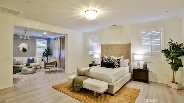 bedroom featuring ornamental molding and light hardwood / wood-style floors