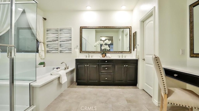 bathroom featuring tile patterned flooring, shower with separate bathtub, and vanity