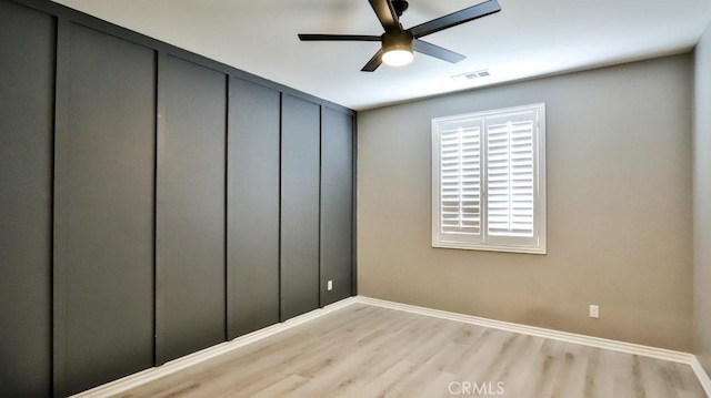 empty room featuring ceiling fan and light hardwood / wood-style floors