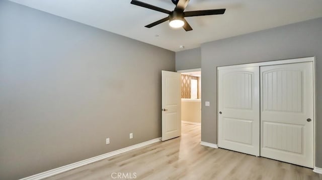 unfurnished bedroom featuring ceiling fan, a closet, and light hardwood / wood-style floors