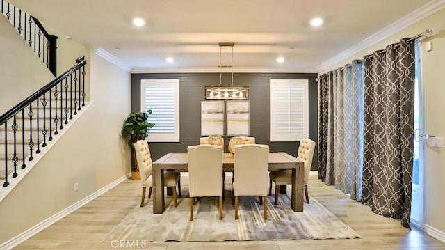 dining area featuring light hardwood / wood-style floors and crown molding