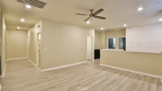 unfurnished room with ceiling fan and light wood-type flooring