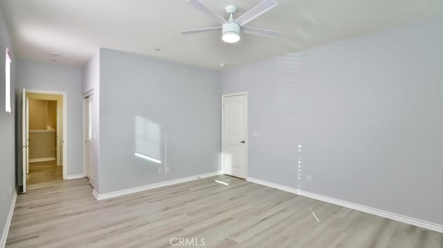 unfurnished room featuring ceiling fan and light wood-type flooring