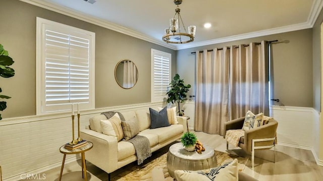 living room with crown molding and a chandelier