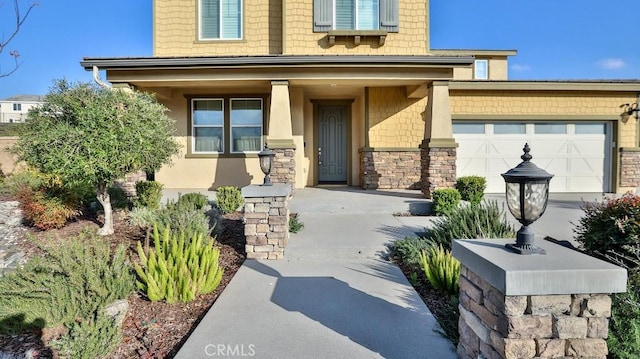 entrance to property featuring a garage and a porch