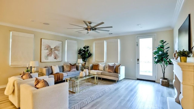 living room featuring ceiling fan, crown molding, and light hardwood / wood-style floors