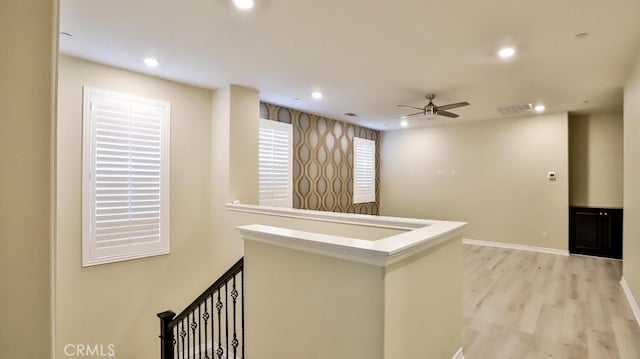 corridor with light hardwood / wood-style flooring