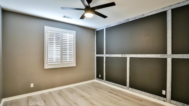 spare room with ceiling fan and hardwood / wood-style flooring