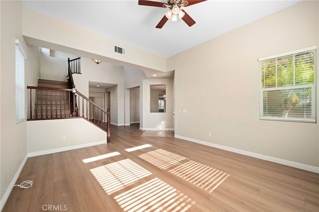 unfurnished living room with ceiling fan and wood-type flooring