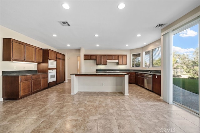 kitchen featuring white appliances and a kitchen island