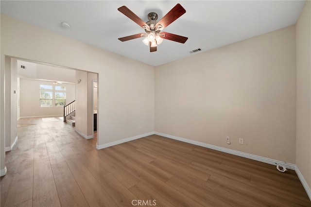 empty room with hardwood / wood-style flooring and ceiling fan