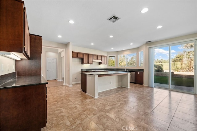 kitchen with a center island, dishwasher, and a breakfast bar