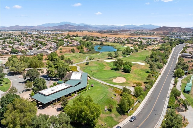 birds eye view of property with a water and mountain view