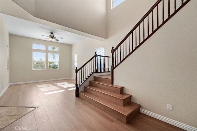 stairway featuring wood-type flooring and ceiling fan